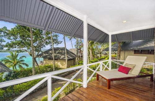 a porch with a chair and a view of the ocean at Iririki Island Resort & Spa in Port Vila