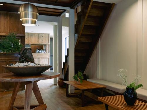 a living room with a staircase and a bowl on a table at LA TERRA narai in Shiojiri