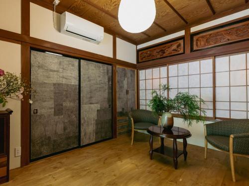 a room with a table and chairs and a window at LA TERRA narai in Shiojiri