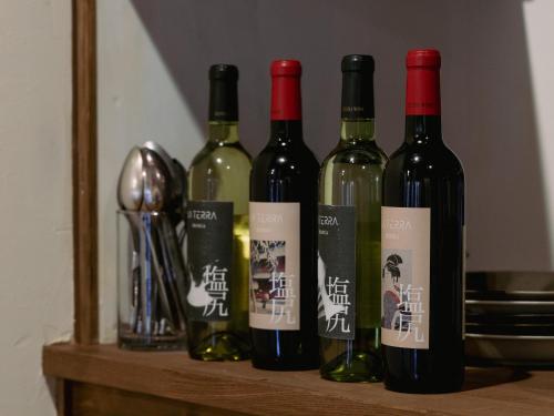a group of wine bottles sitting on a shelf at LA TERRA narai in Shiojiri