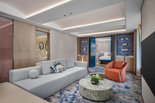 a living room with a couch and a chair at voco Xitang by IHG in Jiaxing