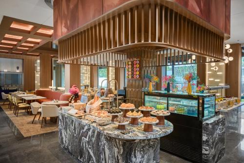 a restaurant with a counter with food on it at voco Xitang by IHG in Jiaxing