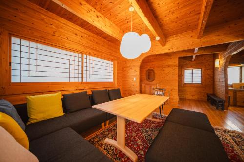 a living room with a couch and a table at Beppu RIN in Beppu