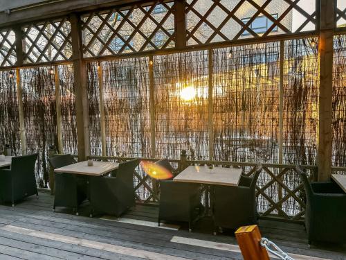 a restaurant with tables and chairs in a building at Newly Refreshed Weaving Mill Stay Free Parking in Oss