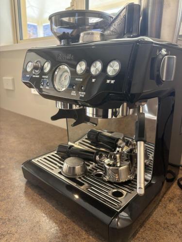 a black coffee maker is sitting on a counter at Alpine Rose Retreat in Arrowtown