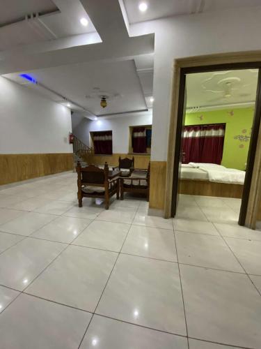 a room with two beds and a table and chairs at Thakur ji haveli in Jaisalmer