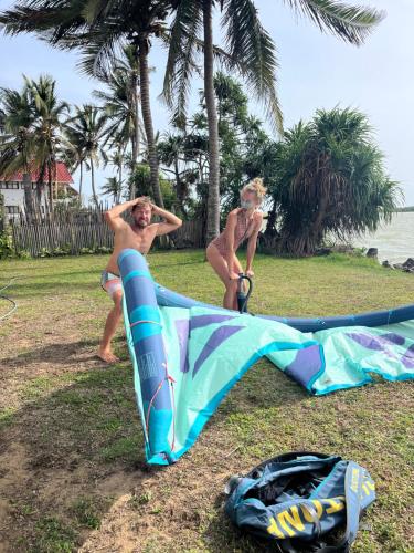 two men in bathing suits standing next to a kite at Mojo in Vannativillu