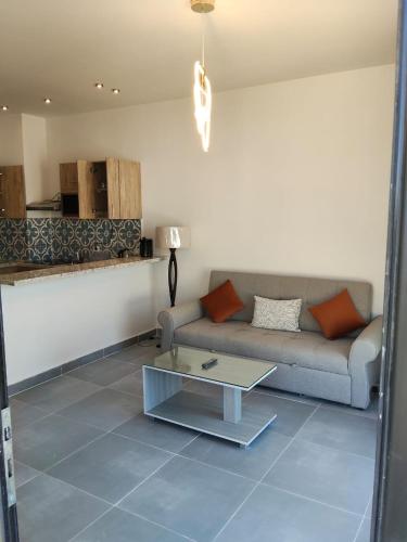 a living room with a couch and a coffee table at One B2b Apartment w balcony with Jacuzzi at Makadi Heights in Hurghada