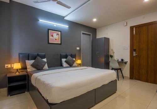 a bedroom with a large bed and a desk at Housr 41 Kondapur, Hyderabad in Hyderabad