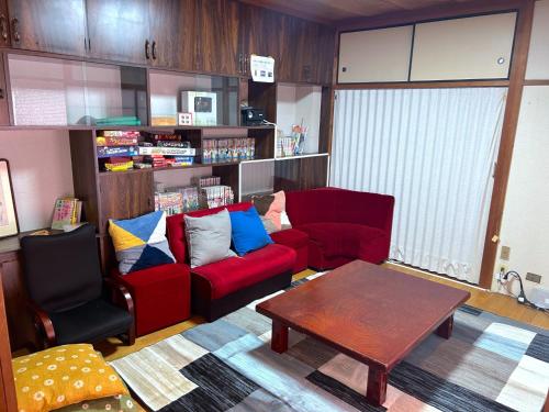 a living room with two red couches and a table at Hokuriku Saikawa Building No,2 Building 3 Floor - Vacation STAY 17642 in Kanazawa
