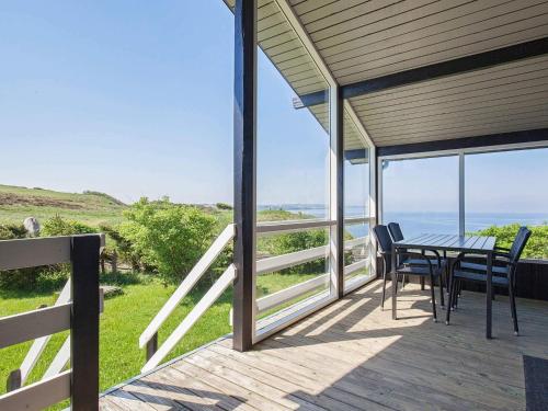 a patio with a table and chairs on a deck at 7 person holiday home in Struer-By Traum in Remmer Strand
