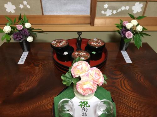 a table with three vases with flowers in them at 8-17 Nomura Motomachi - House / Vacation STAY 1893 in Hirakata