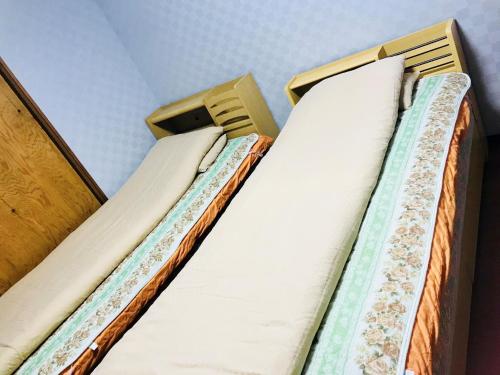two bunk beds in a room with white pillows at Hannan - House / Vacation STAY 47627 in Hannan
