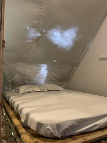 a bed in a tent in a room at Elementzz community in Kottakupam