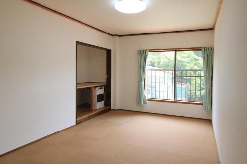 an empty living room with a large window at Cottage All Resort Service / Vacation STAY 8438 in Inawashiro