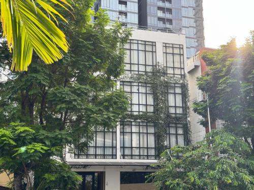 a building with windows and trees in a city at Silom Nara in Bangkok