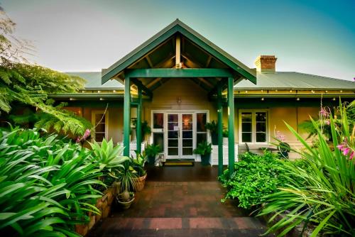 a house with a front porch with plants at Margaret River Guest House in Margaret River Town