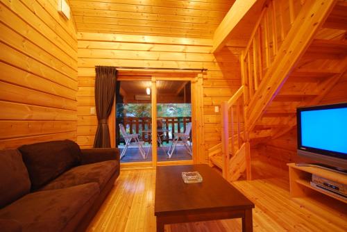 a living room with a couch and a flat screen tv at Cottage All Resort Service / Vacation STAY 8441 in Inawashiro