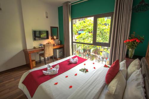 a bedroom with a bed and a window with flowers on it at NT Old Gate Hostel in Hanoi