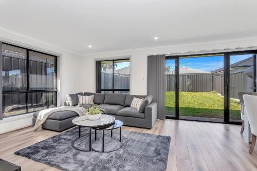 a living room with a couch and a table at East Haven Creek 