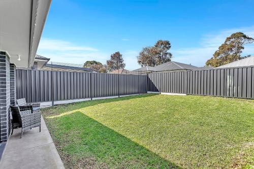 a backyard with a fence and a lawn at East Haven Creek 