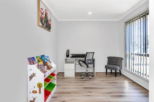a white room with a desk and a chair at East Haven Creek 