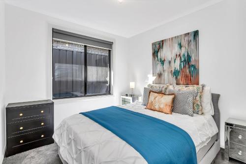 a bedroom with a bed and a painting on the wall at East Haven Creek 