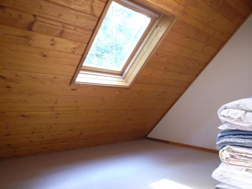 a room with a window and a pile of towels at Cottage All Resort Service / Vacation STAY 8422 in Inawashiro
