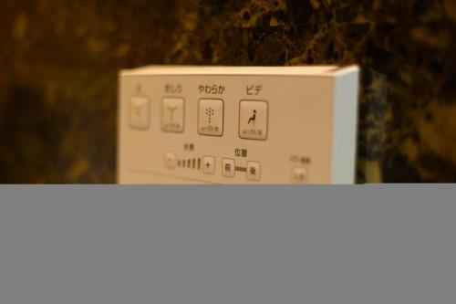 a white microwave sitting on top of a counter at Guest house Kintoto - Vacation STAY 9778 in Kanazawa