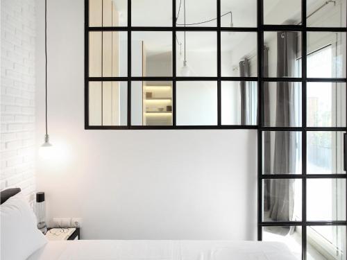 a bedroom with black framed windows and a bed at Athens View Loft - 03 in Athens