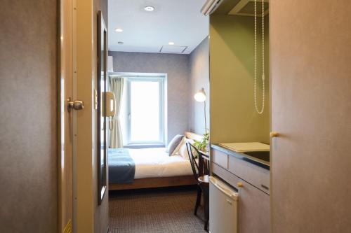 a small bedroom with a bed and a window at Sapporo - Apartment - Vacation STAY 43085v in Sapporo