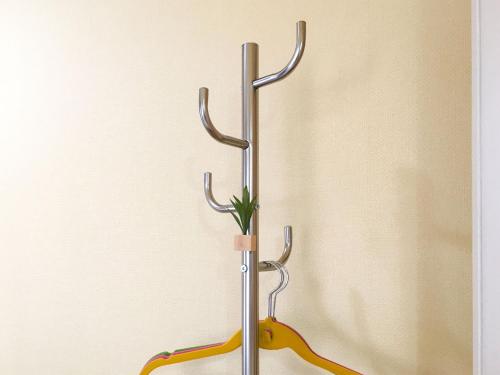 a metal towel rack with a plant in it at Pension Marinetown Aratta Vacation STAY 13299 in Yonabaru