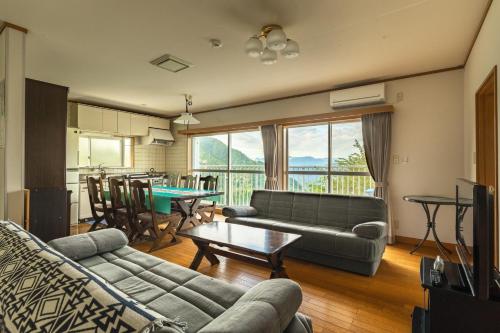 a living room with a couch and a table at Kanra-gun - House / Vacation STAY 2833 in Karuizawa