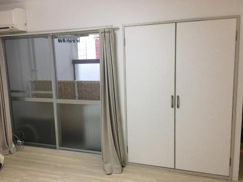 a room with a white cabinet and a window at Room 202 / Vacation STAY 13909 in Tokushima