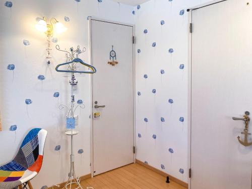 a room with a door with blue flowers on the wall at Pension Marinetown Aratta Vacation STAY 13299 in Gaja