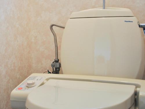 a white toilet in a bathroom with a control panel at Kawagoe - House - Vacation STAY 16212 in Kawagoe