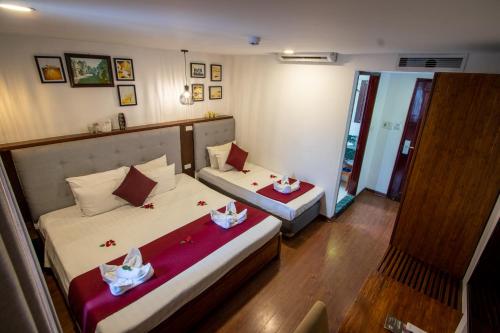 a hotel room with two beds and a mirror at NT Old Gate Hostel in Hanoi