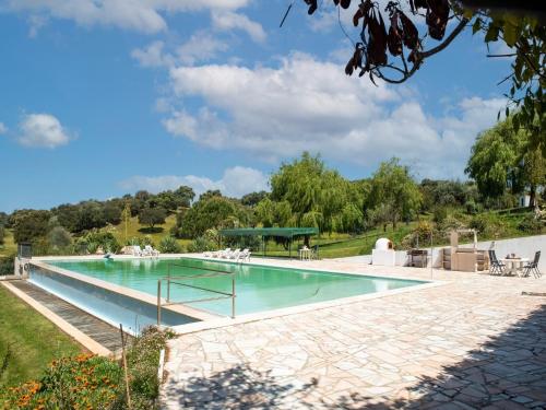 a swimming pool in a villa with a garden at Farmhouse in Montemor near Évora in Montemor-o-Novo