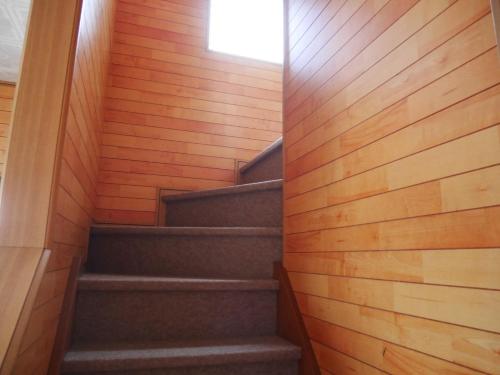 a staircase in a house with wooden walls at Guest House Inujima / Vacation STAY 3516 in Toyama