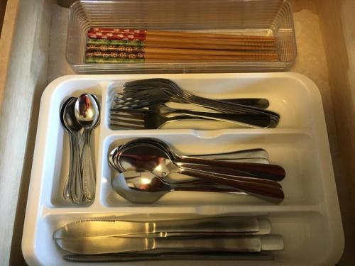 a white tray with utensils in a drawer at Nikko Guest House / Vacation STAY 16645 in Nikko