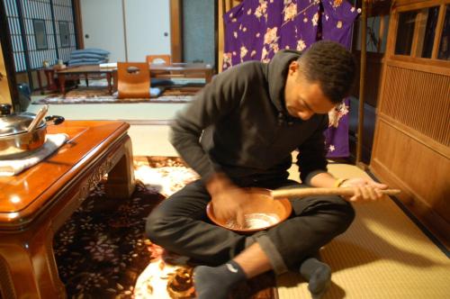 a man sitting on the floor playing a guitar at Tabinoya / Vacation STAY 17823 in Kakegawa