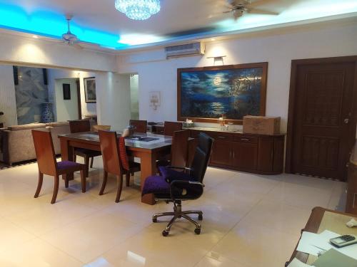 a dining room with a table and chairs at Luxury Furnished apartment 3400sq in Dhaka
