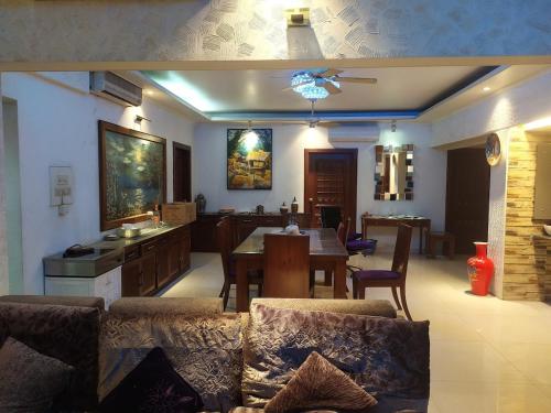 a kitchen and dining room with a table and chairs at Luxury Furnished apartment 3400sq in Dhaka