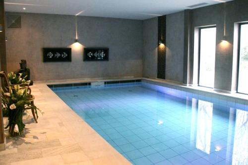a pool in a house with a swimming pool at Hotel Gut Bardenhagen in Bardenhagen