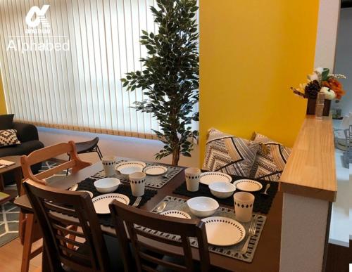 a table with plates and cups on it in a room at Alphabed TakamatsuHyogomachi 602 / Vacation STAY 21871 in Takamatsu