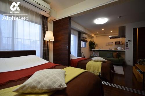 ein Hotelzimmer mit zwei Betten und einem Fenster in der Unterkunft Alphabed TakamatsuFurujinmachi 902 / Vacation STAY 21916 in Takamatsu