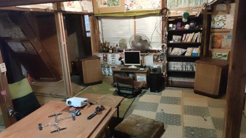 a room with a desk and a computer in it at Gegege no Guesthouse - Vacation STAY 9461 in Uozu