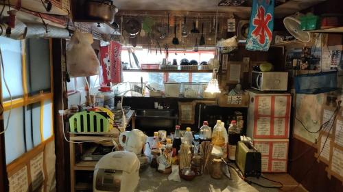 a kitchen with a counter with dishes and utensils at Gegege no Guesthouse - Vacation STAY 9461 in Uozu