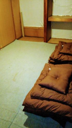 a brown sleeping bag sitting on the floor in a room at Gegege no Guesthouse - Vacation STAY 9461 in Uozu