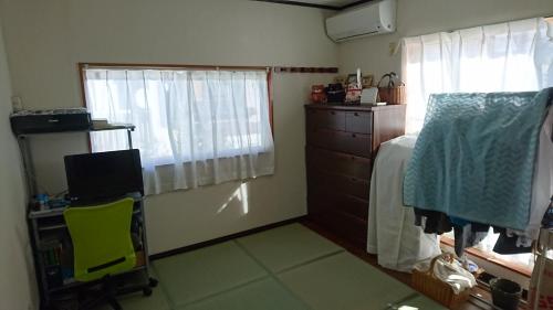 a bedroom with a bed and a chair and a window at Toride - House / Vacation STAY 4015 in Toride